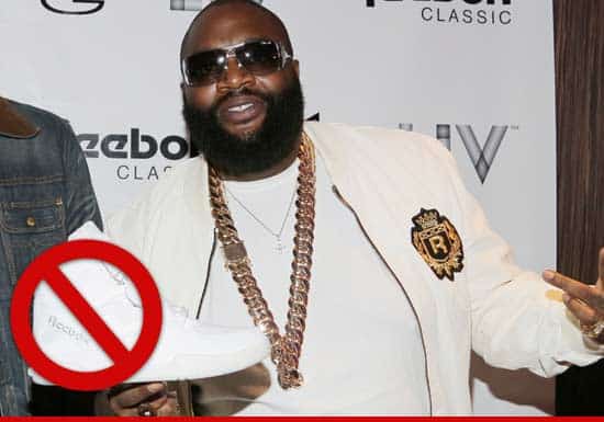 Rick Ross holding up the shoe he's no longer paid to endorse. Oh.